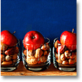 christmas decoration: glass tumblers filled with apples and nuts