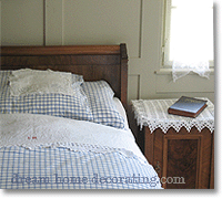 antique Swiss bedrooom with blue-and-white checked bedlinen
