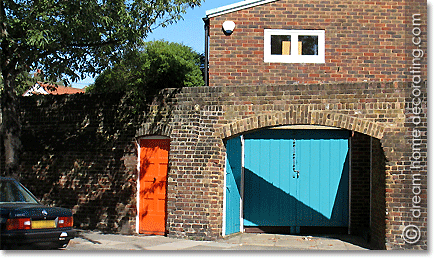 brick house with turquoise and orange color entrances