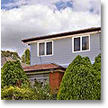 pale blue-grey house in a garden