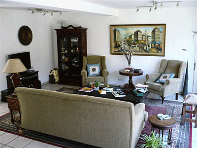 Contemporary German living room with white walls and white floor tiles