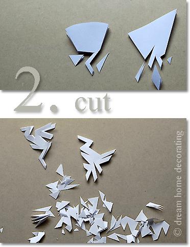 cutting folded paper to create a snowflake pattern