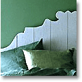 pale blue-grey headboard and green bedding
