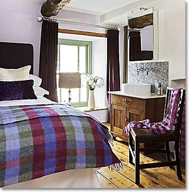 scottish inspired country bedroom with purple accents