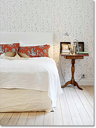 red toile pillows in a white Swedish bedroom