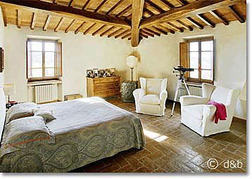 bright traditional bedroom in a Tuscan villa