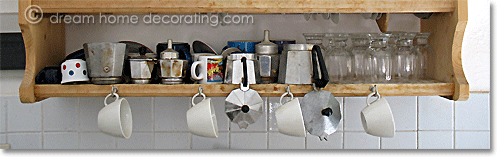 wooden dish rack in Italy with stovetop espresso makers, glasses and cups