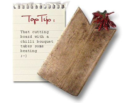 antique wooden cutting board with a bouquet of chillies