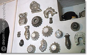 vintage baking tins on a white wall, Tuscany