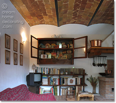restored living room area in a Tuscan farmhouse with a barrel-vault brick ceiling, Province of Pisa, Italy