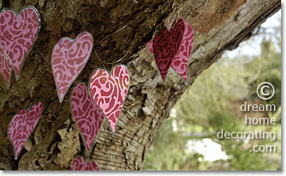 valentine day outdoor decoration: make a garland out of laminated heart shapes