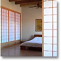 western bedroom with brick walls and shoji screens