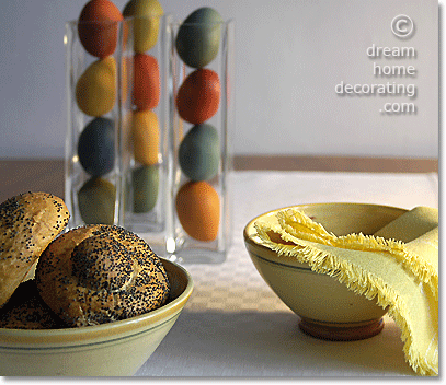 Hand-dyed Easter eggs in narrow glass vases on an Easter table