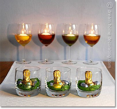 Little Easter nests in glass tumblers and floating candles in food-dyed water