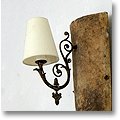 french wall sconce mounted to antique roofing tile