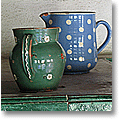 earthenware jugs on a Swiss tiled oven