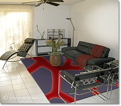 White Arizona living room with black furniture and an area rug in red and purple