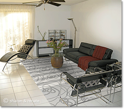 White Arizona living room with black furniture and a black-grey-and-white patterned area rug