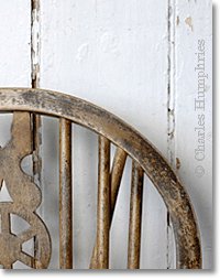 Windsor chair back against a white wall