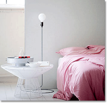 White bedroom with pink bedlinen, Holland.