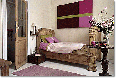 Antique bed with purple and pink accent colors