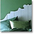 blue-grey headboard and green bedding