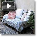 French country daybed in a courtyard