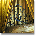 elegant black Tuscan headboard made of scrolled wrought iron