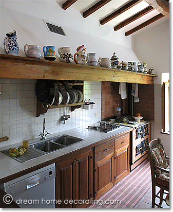 Tuscan farmhouse kitchen with collection of ceramic jugs, Province of Pisa, Tuscany, Italy