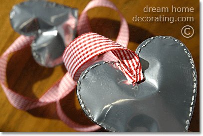 silver valentine hearts: staple a ribbon to the top back of the heart. Conceal the ribbon end.