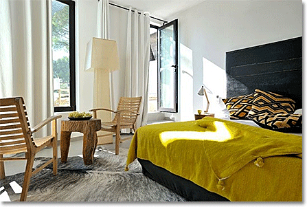 neutral bedroom with mustard yellow bedspread