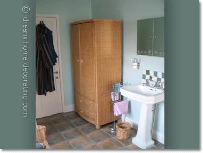Mint bathroom walls with old washstand & wicker cupboard