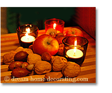 tealights in fifties shots glasses, surrounded by nuts and apples