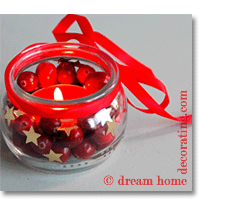 christmas light made of a glass filled with cranberries and gold stars