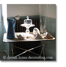 side table with glass cloche and seashells in Provence, France