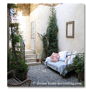 sofa with toile de jouy in a French country courtyard