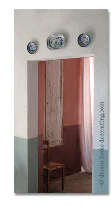 blue and white plates above a French country doorway
