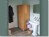 Mint bathroom walls with old washstand & wicker cupboard