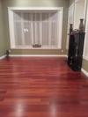 Cherry red hardwood floor, black fireplace, green walls