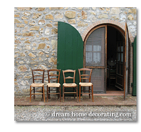 straw-seated chairs in front of a Tuscan farmhouse