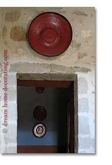 french country colors: rustic plate above a stone doorway