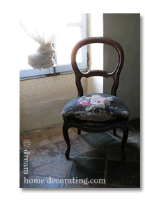 french chair and cheesecloth window treatments