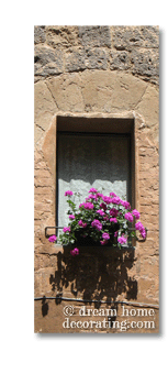 tuscan window with white cotton curtain and geranium box