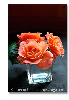 salmon colored roses on a black background